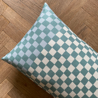 Checkered pillow on a wooden floor