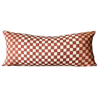 Checkered pillow with red and white pattern on a white background