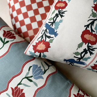 Close-up of patterned cushions with floral and checkered designs.