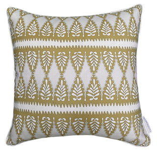 Decorative pillow with ochre and white geometric pattern on a natural background