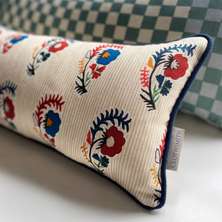Decorative pillow with floral patterns on a checkered background