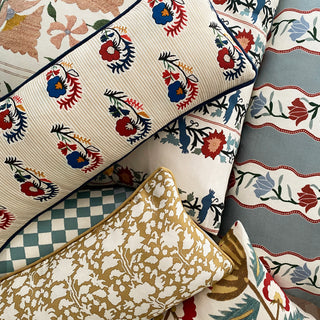 Collection of patterned fabrics with floral and geometric designs.