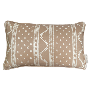 Decorative pillow with blush pink and cream pattern on a white background