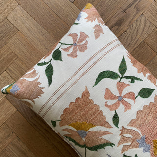 Floral-patterned pillow on a wooden floor